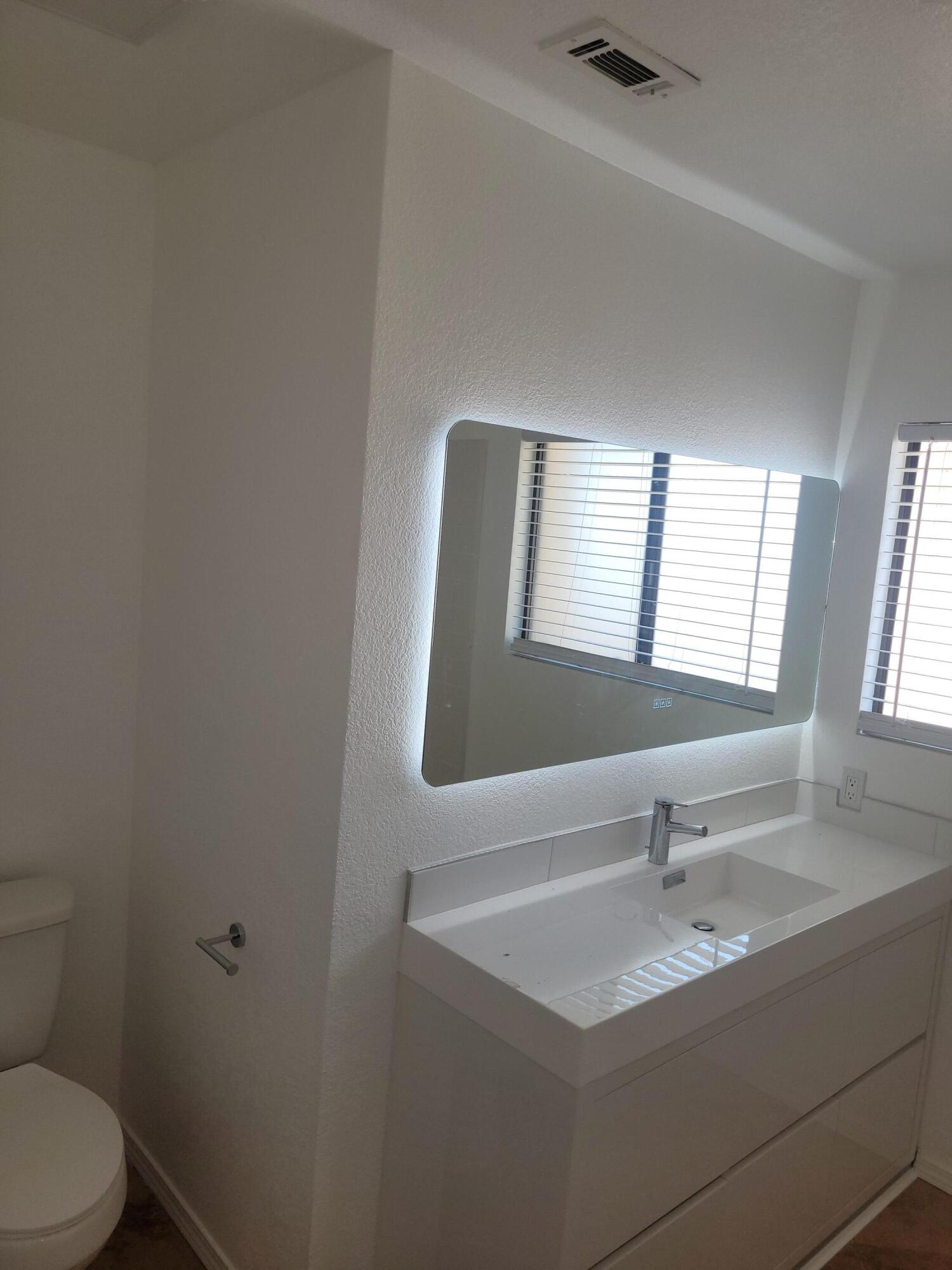 70380 Chappel Road Rancho Mirage, CA 92270 - Photo 28 of 30 a bathroom with a sink toilet and mirror