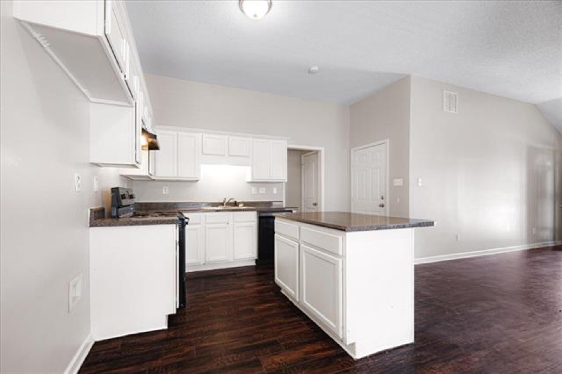 5569 Falling Bark Drive Memphis, TN 38134 - Photo 13 of 31 a kitchen with stainless steel appliances and white cabinets