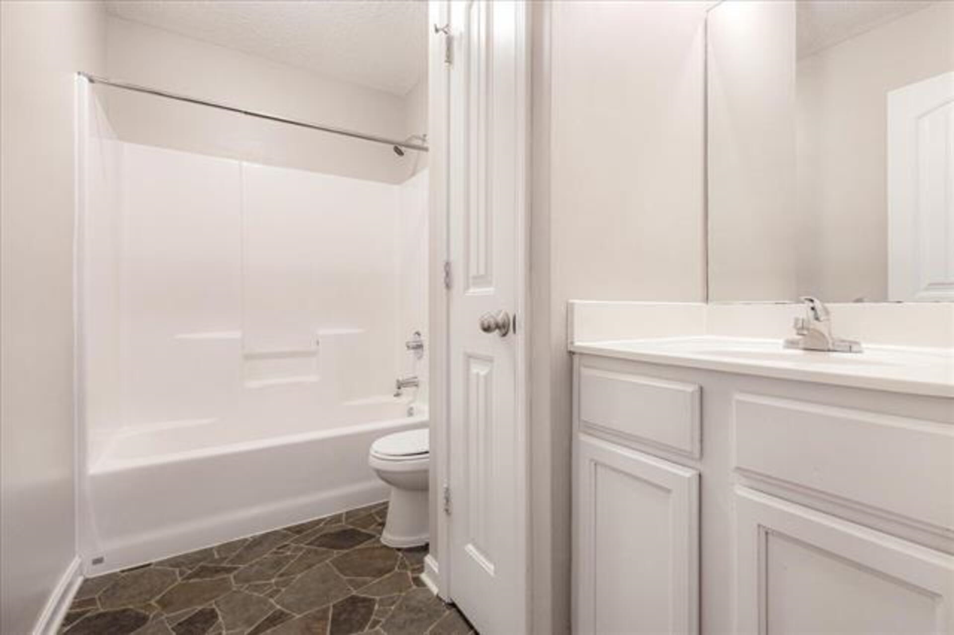 5569 Falling Bark Drive Memphis, TN 38134 - Photo 16 of 31 a bathroom with a sink a toilet and shower