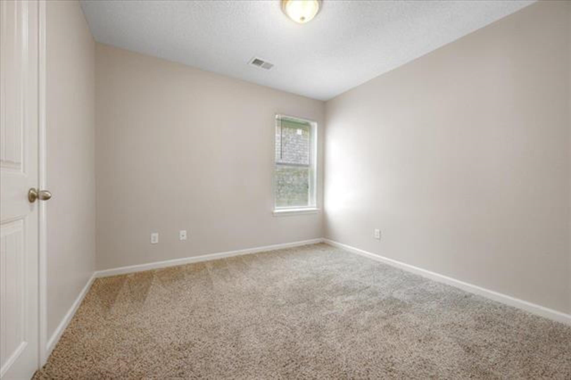 5569 Falling Bark Drive Memphis, TN 38134 - Photo 17 of 31 an empty room with windows and closet
