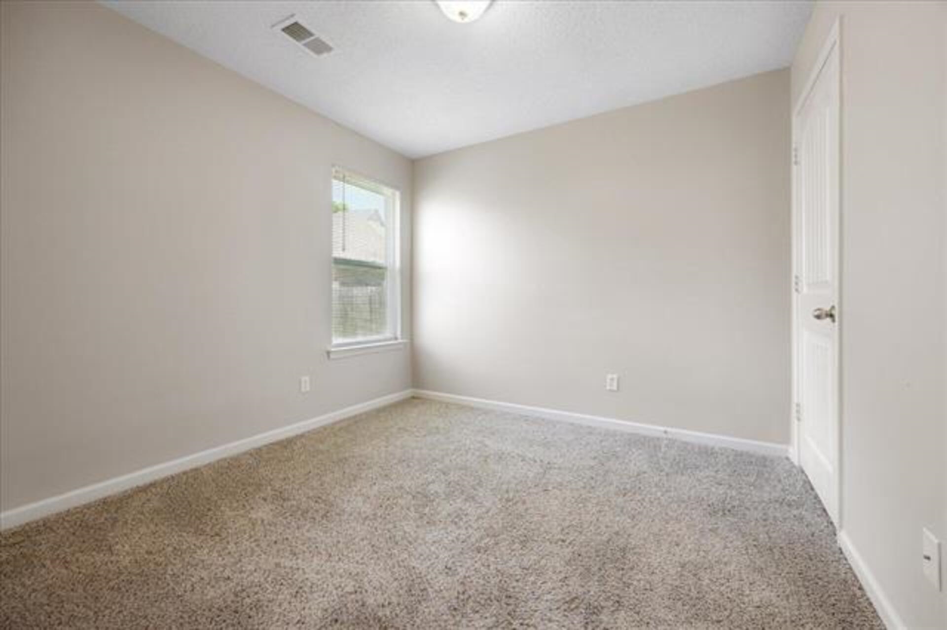5569 Falling Bark Drive Memphis, TN 38134 - Photo 18 of 31 an empty room with windows and closet
