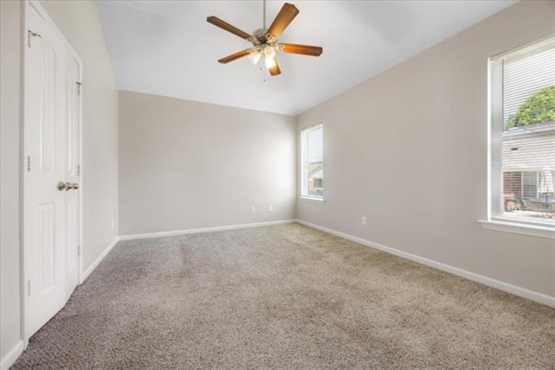 5569 Falling Bark Drive Memphis, TN 38134 - Photo 19 of 31 an empty room with windows and fan