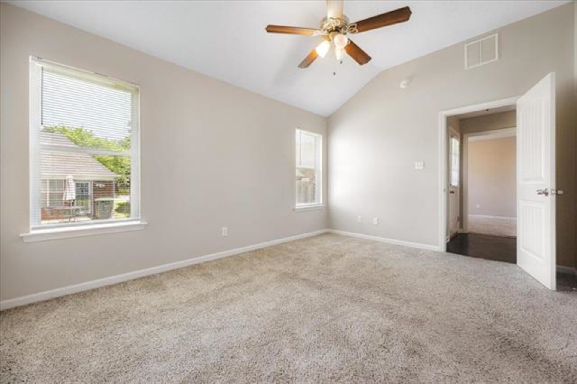 5569 Falling Bark Drive Memphis, TN 38134 - Photo 20 of 31 an empty room with windows and fan