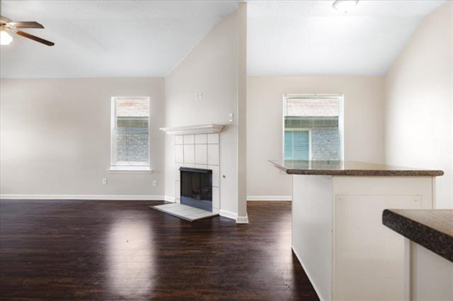 5569 Falling Bark Drive Memphis, TN 38134 - Photo 26 of 31 a view of empty room with wooden floor and fireplace