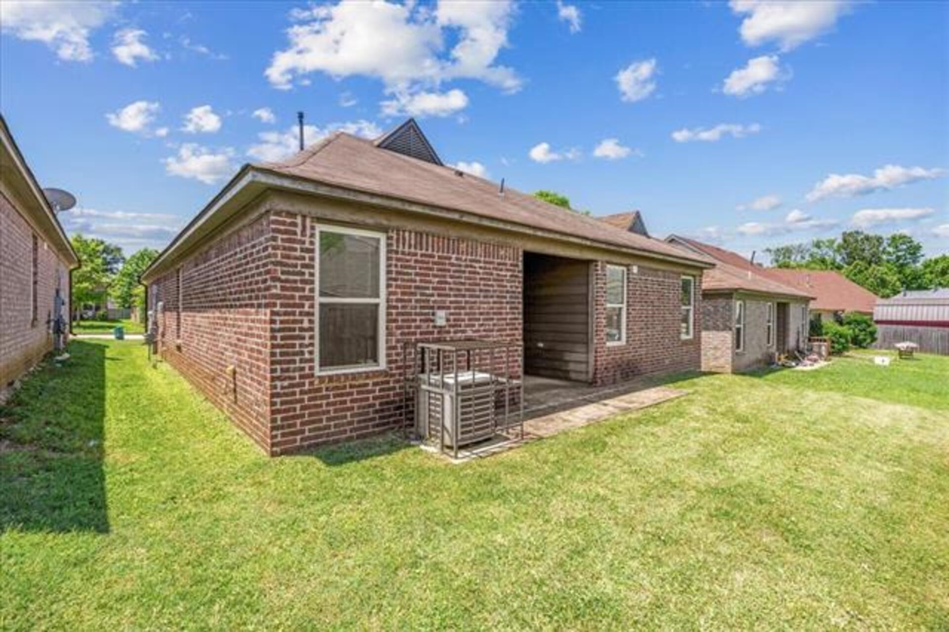 5569 Falling Bark Drive Memphis, TN 38134 - Photo 27 of 31 a front view of a house with a garden