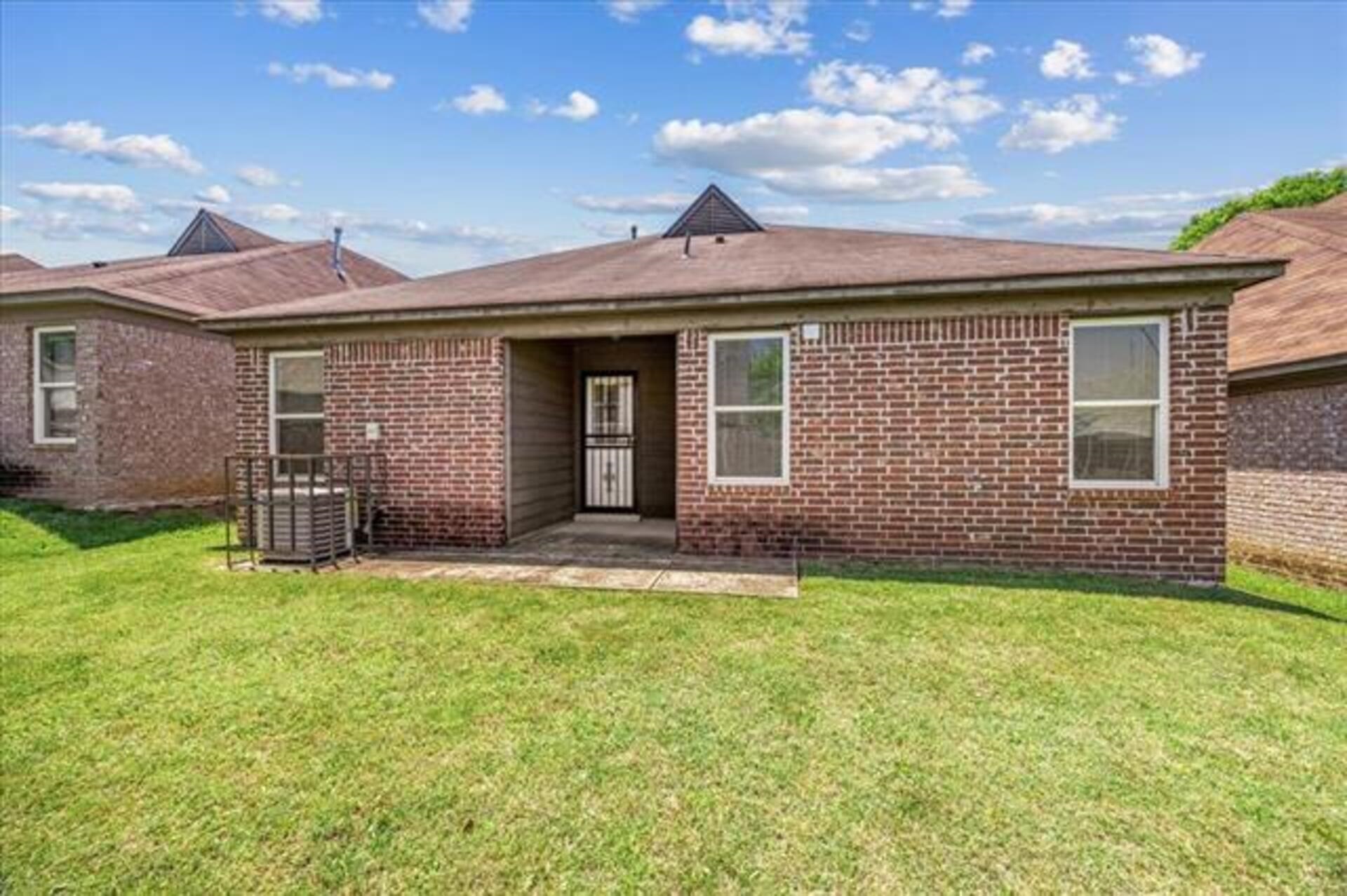 5569 Falling Bark Drive Memphis, TN 38134 - Photo 28 of 31 a view of a brick house with a big yard and large trees