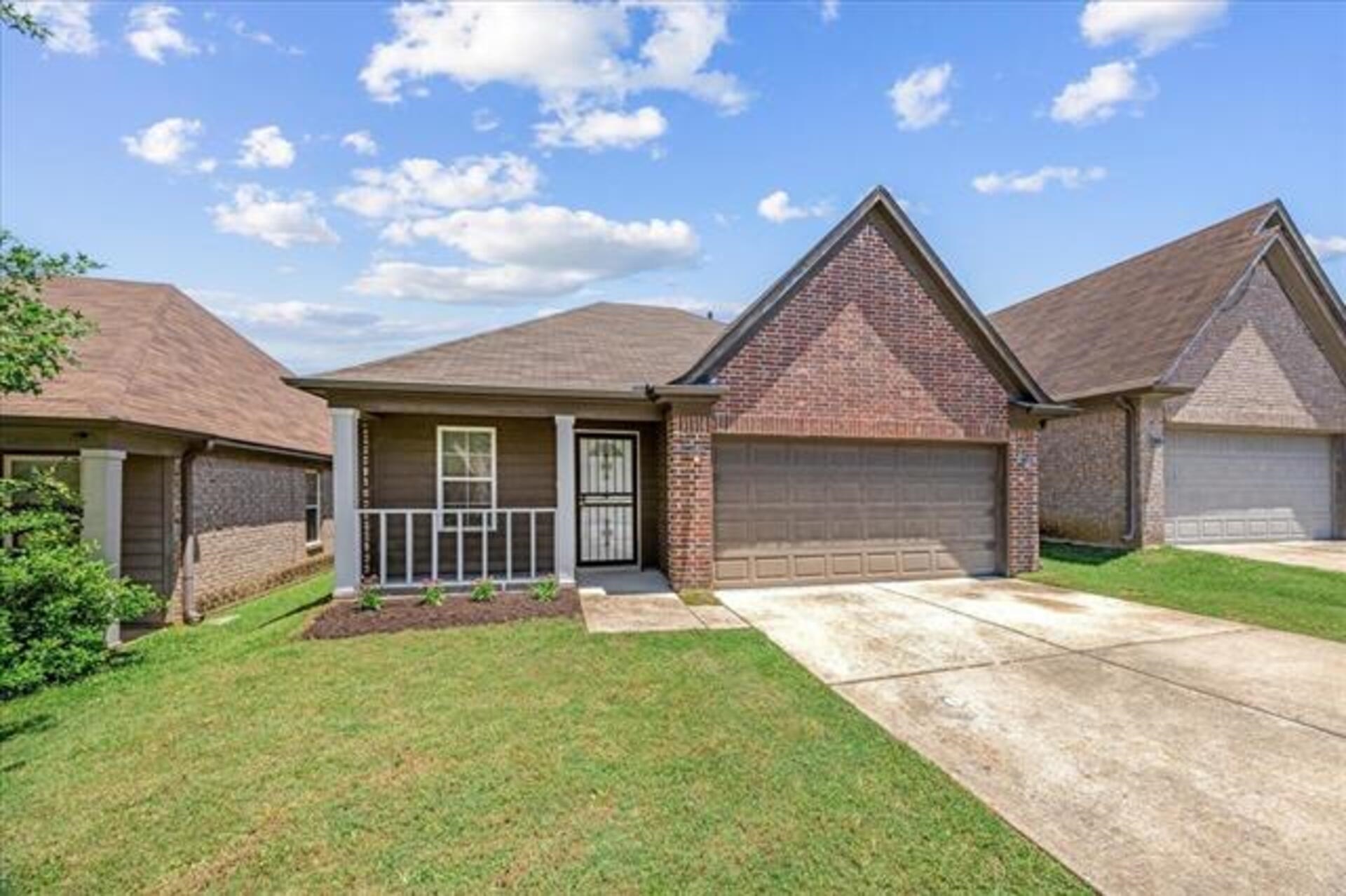 5569 Falling Bark Drive Memphis, TN 38134 - Photo 31 of 31 a front view of a house with a yard and garage