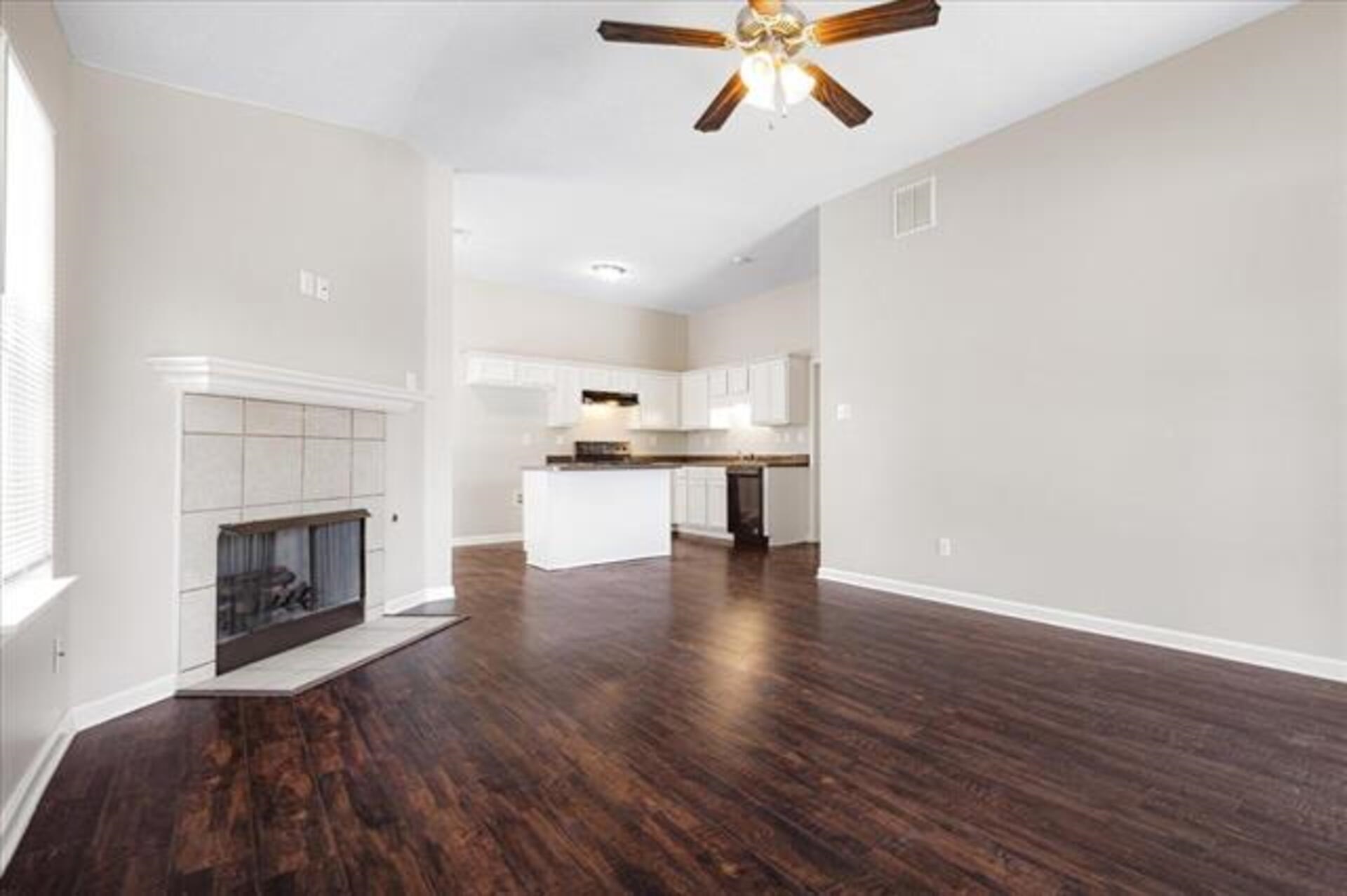 5569 Falling Bark Drive Memphis, TN 38134 - Photo 10 of 31 a view of kitchen with microwave a stove and wooden floor