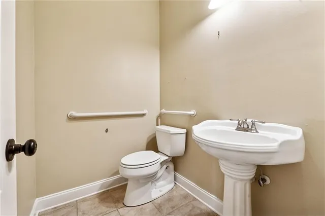 a white toilet sitting next to a white sink