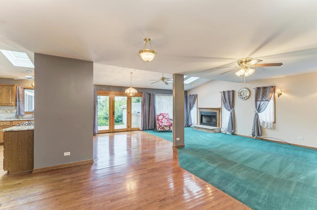 457 Fall Circle Roselle, IL 60172 - Photo 16 of 37 a view of an empty room with window and wooden floor