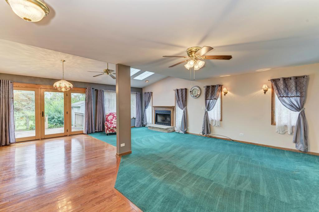457 Fall Circle Roselle, IL 60172 - Photo 17 of 37 a view of an empty room with window and wooden floor