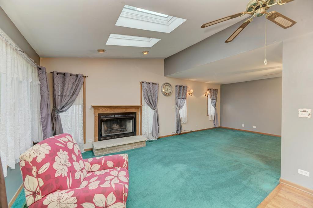457 Fall Circle Roselle, IL 60172 - Photo 18 of 37 a living room with furniture and a fireplace