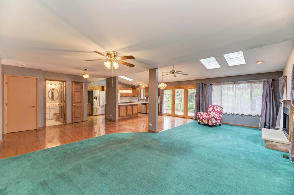 457 Fall Circle Roselle, IL 60172 - Photo 19 of 37 a view of a livingroom with furniture wooden floor and a fireplace