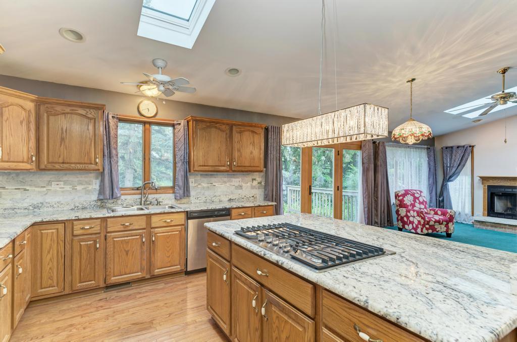 457 Fall Circle Roselle, IL 60172 - Photo 23 of 37 a kitchen with kitchen island granite countertop a stove and a large cabinets