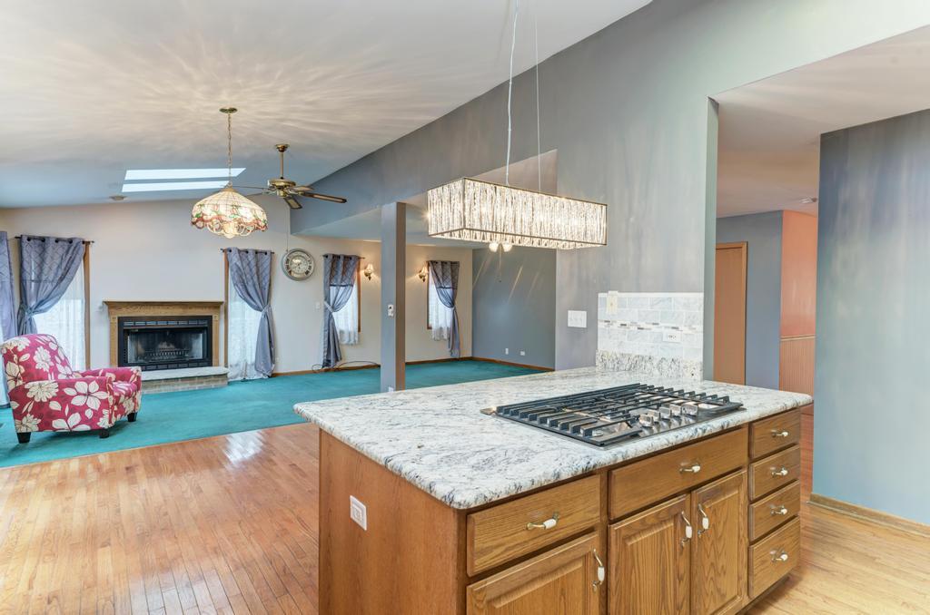 457 Fall Circle Roselle, IL 60172 - Photo 24 of 37 a kitchen view of kitchen island granite countertop stove top oven and cabinets