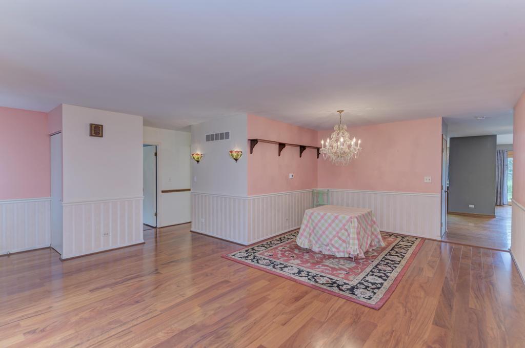 457 Fall Circle Roselle, IL 60172 - Photo 7 of 37 a room with wooden floor and white walls