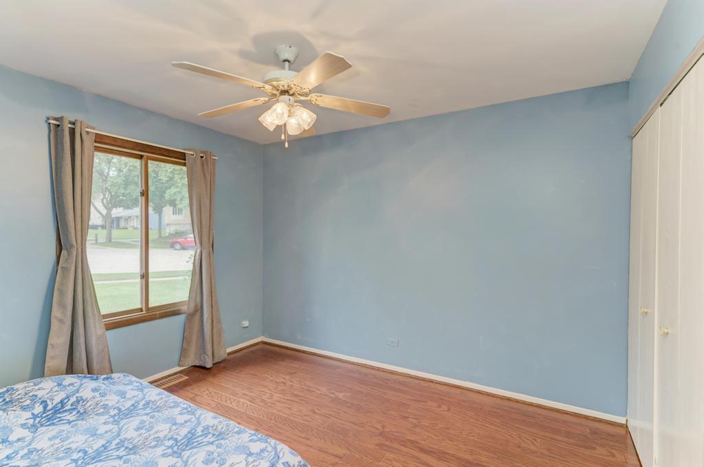 457 Fall Circle Roselle, IL 60172 - Photo 8 of 37 a view of an empty room with wooden floor and a window