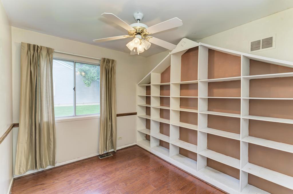457 Fall Circle Roselle, IL 60172 - Photo 9 of 37 a view of an empty room with a window and wooden floor