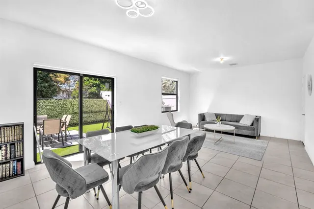 a view of a dining room with furniture and a potted plant