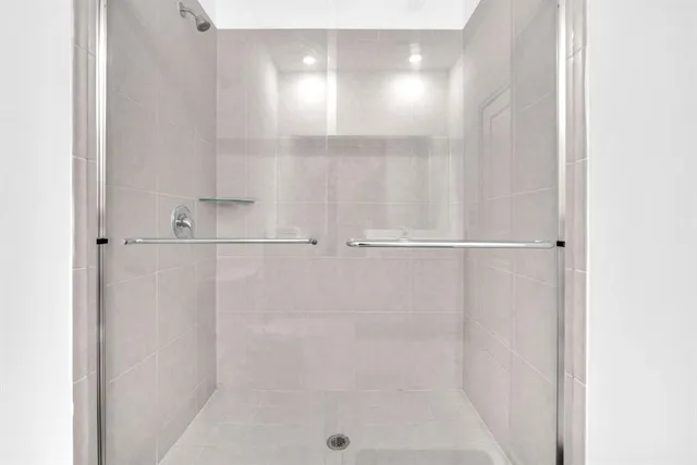 a view of walk in closet with clothes