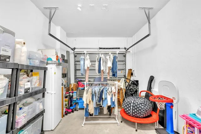a view of a chairs and table in patio next to a yard