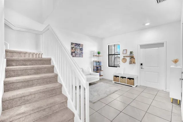 a view of a hallway with stairs and furniture
