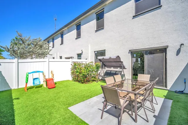 a view of backyard with outdoor seating and plants