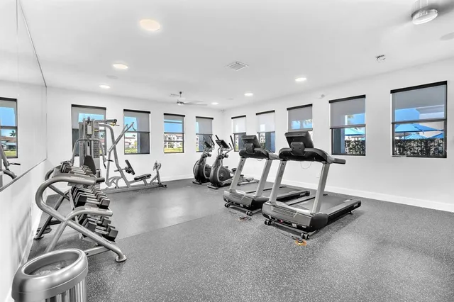 a view of a swimming pool with chairs and tables