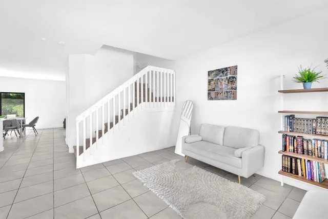 a living room with furniture and a book shelf