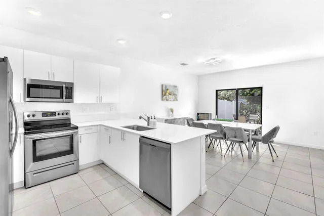 a kitchen with a stove a sink and a microwave