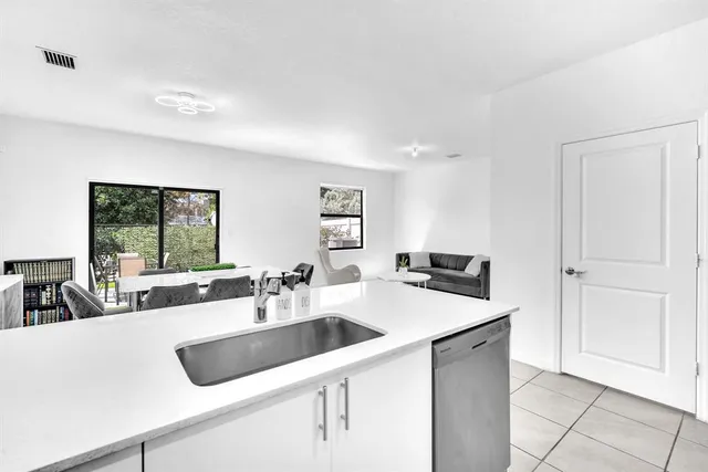 a view of a kitchen island a sink and living room