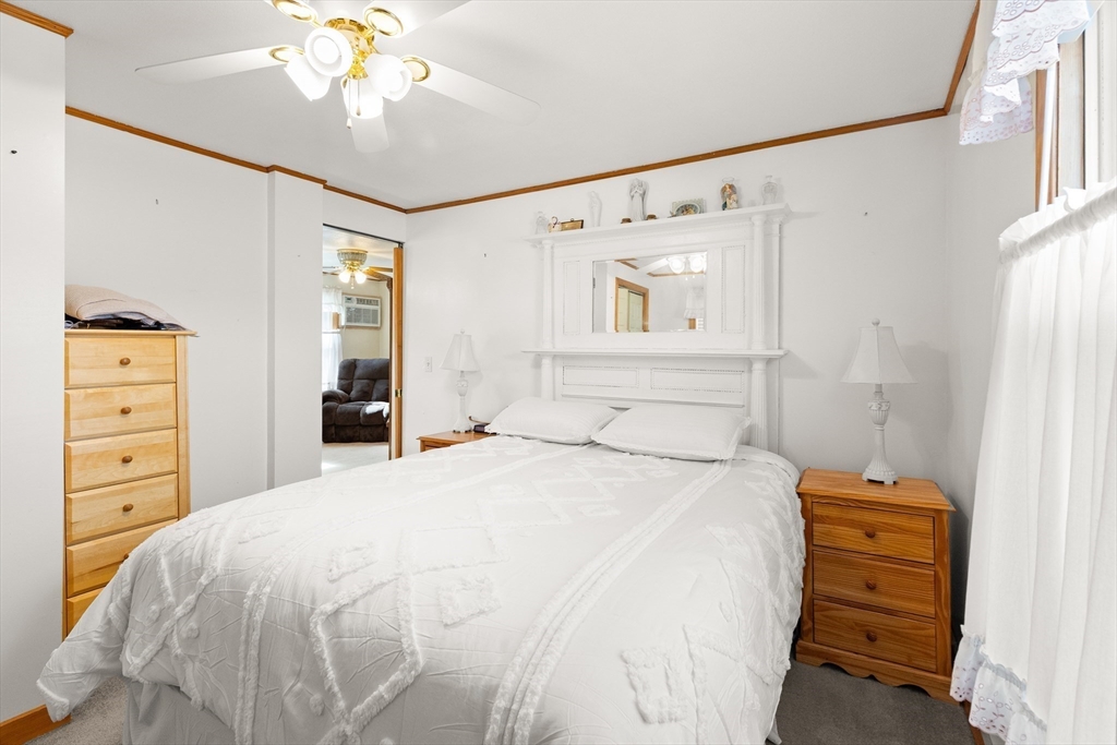 35 Lafayette Road Salisbury, MA 01952 - Photo 3 of 40 a bedroom with a bed and a chandelier