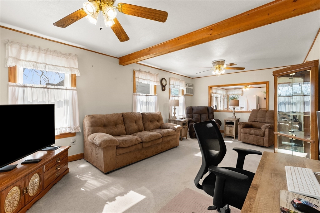 35 Lafayette Road Salisbury, MA 01952 - Photo 5 of 40 a living room with furniture a flat screen tv and a fireplace