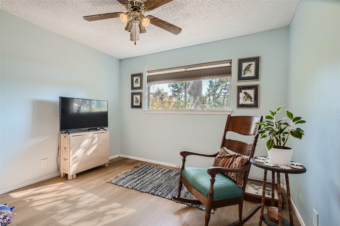 9206 Robins Nest Lane Austin, TX 78729 - Photo 12 of 18 a living room with furniture and a flat screen tv