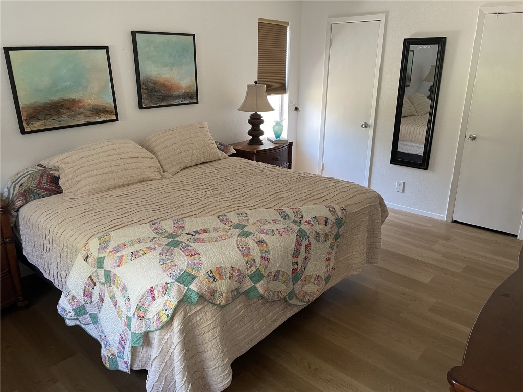 9206 Robins Nest Lane Austin, TX 78729 - Photo 8 of 18 a bedroom with a bed and a painting on the wall