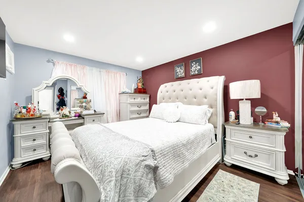 a bed room with a bed and a dresser
