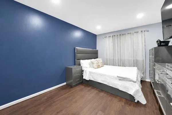 a bed room with a bed and a television