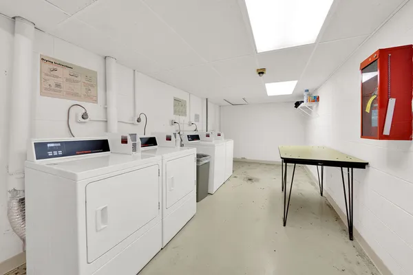 a utility room with cabinets washer and dryer
