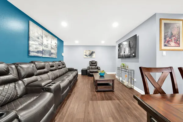 a living room with furniture and a wooden floor