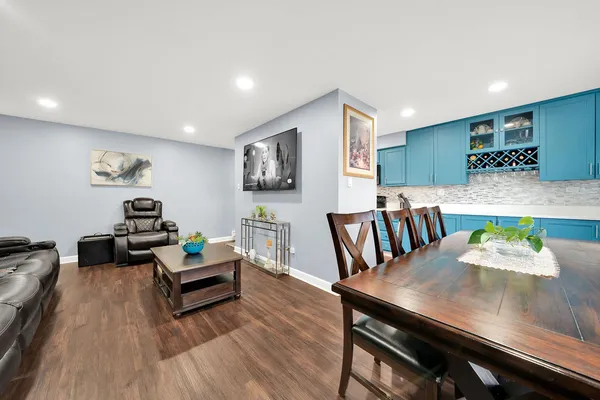 a living room with furniture and wooden floor