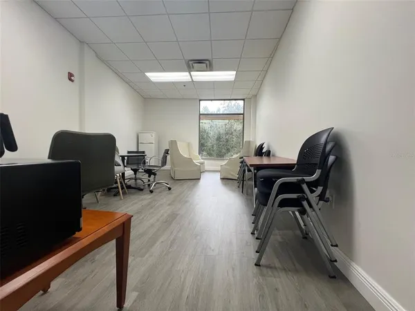 a workspace with furniture hardwood and a window