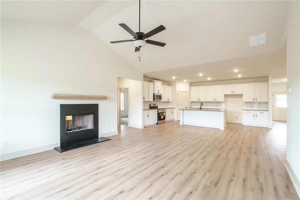 224 Good Hope Preserve Good Hope, GA 30641 - Photo 22 of 60 a living room with stainless steel appliances kitchen island a fireplace and wooden floor