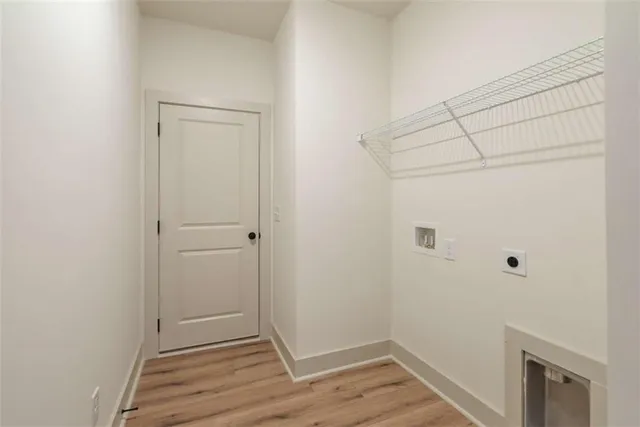 a view of a livingroom with wooden floor and staircase