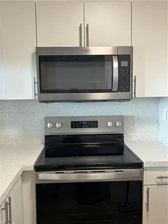 a stove top oven sitting inside of a kitchen
