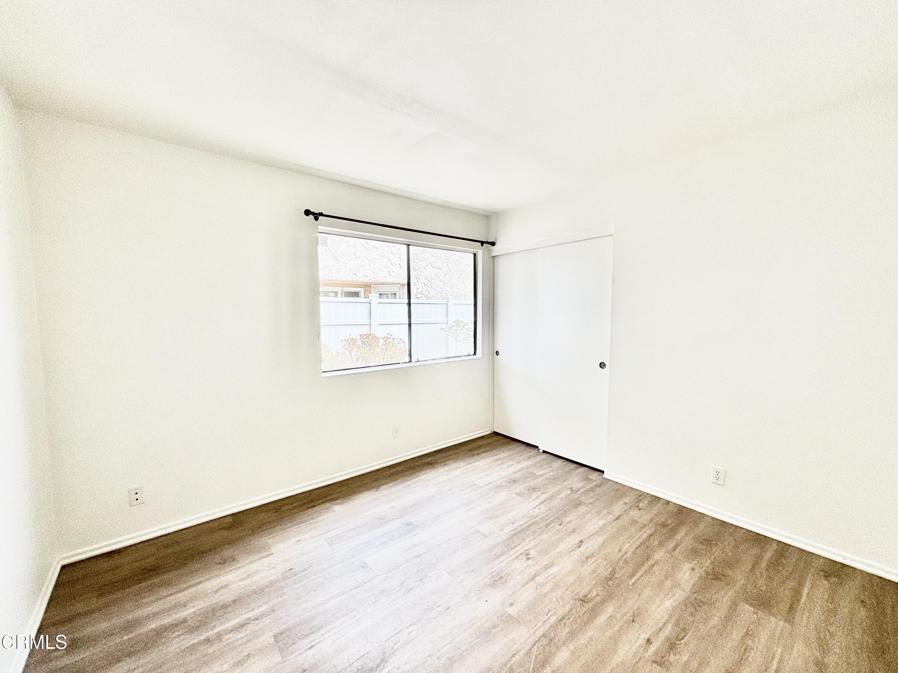4911 Catamaran Street Oxnard, CA 93035 - Photo 12 of 38 an empty room with wooden floor and windows