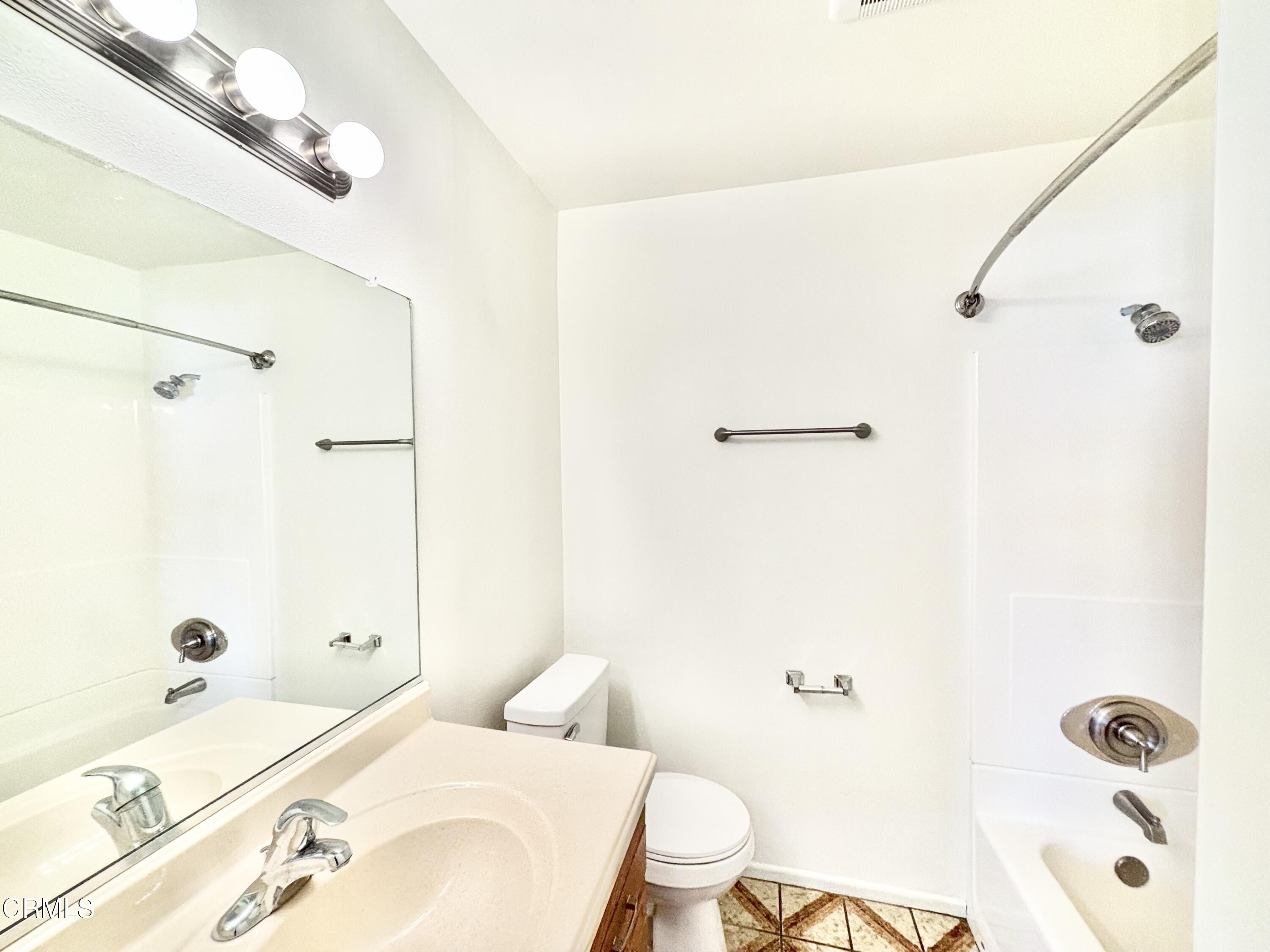 4911 Catamaran Street Oxnard, CA 93035 - Photo 15 of 38 a bathroom with a sink a toilet and shower