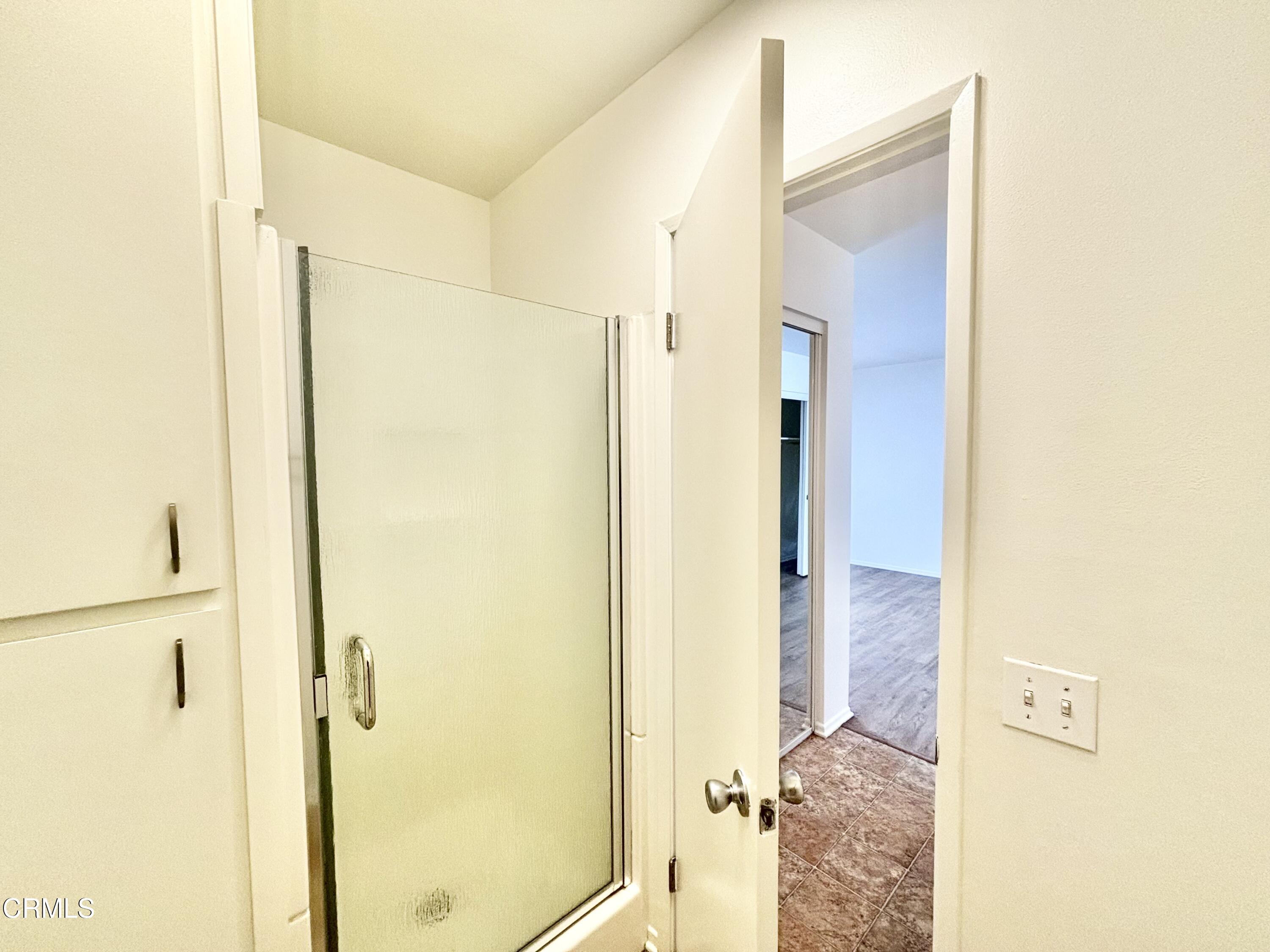 4911 Catamaran Street Oxnard, CA 93035 - Photo 26 of 38 a bathroom with a shower and a door
