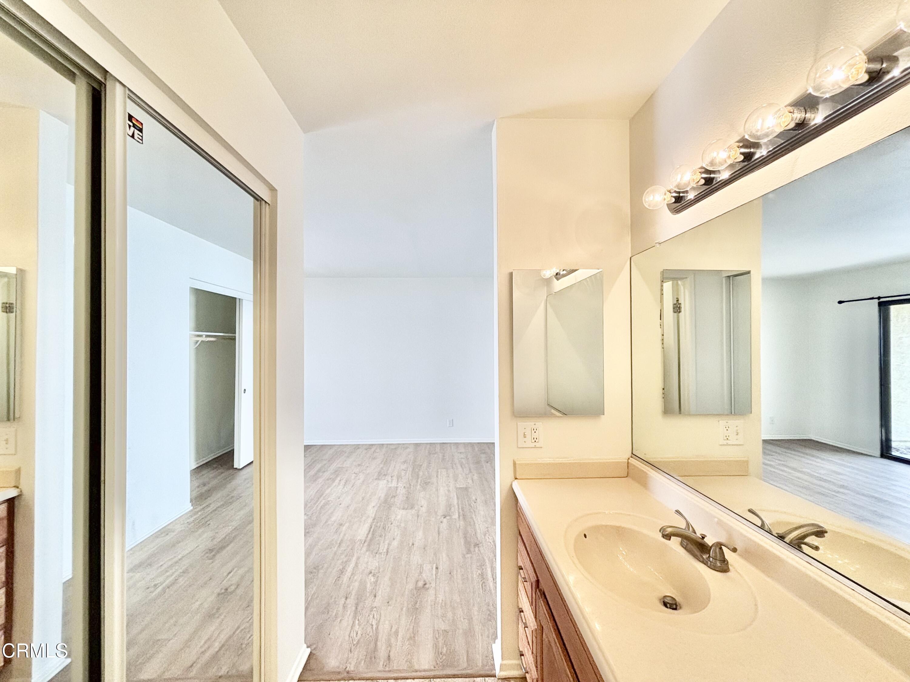 4911 Catamaran Street Oxnard, CA 93035 - Photo 27 of 38 a bathroom with a tub sink and mirror