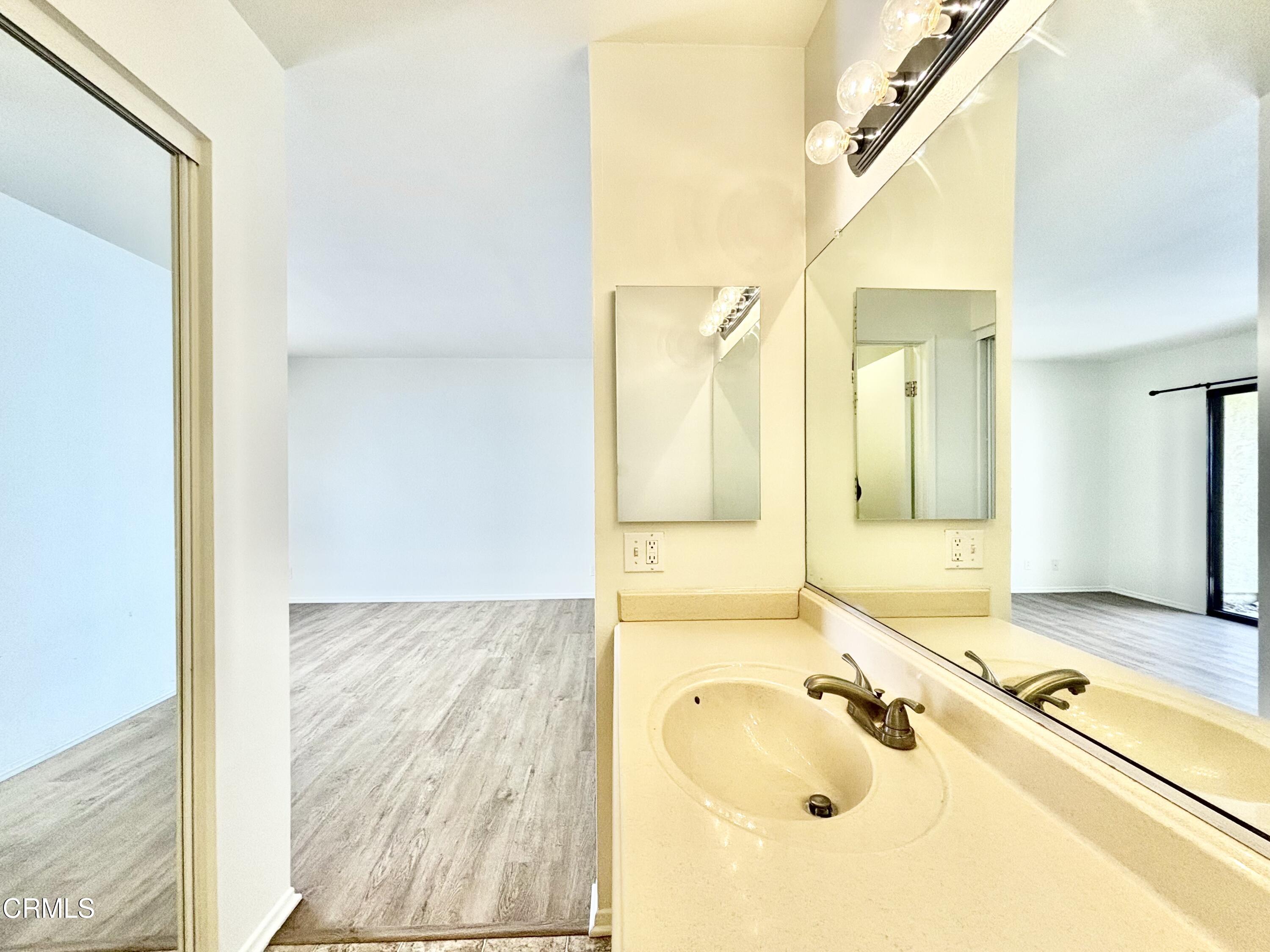 4911 Catamaran Street Oxnard, CA 93035 - Photo 28 of 38 a bathroom with a tub sink and mirror