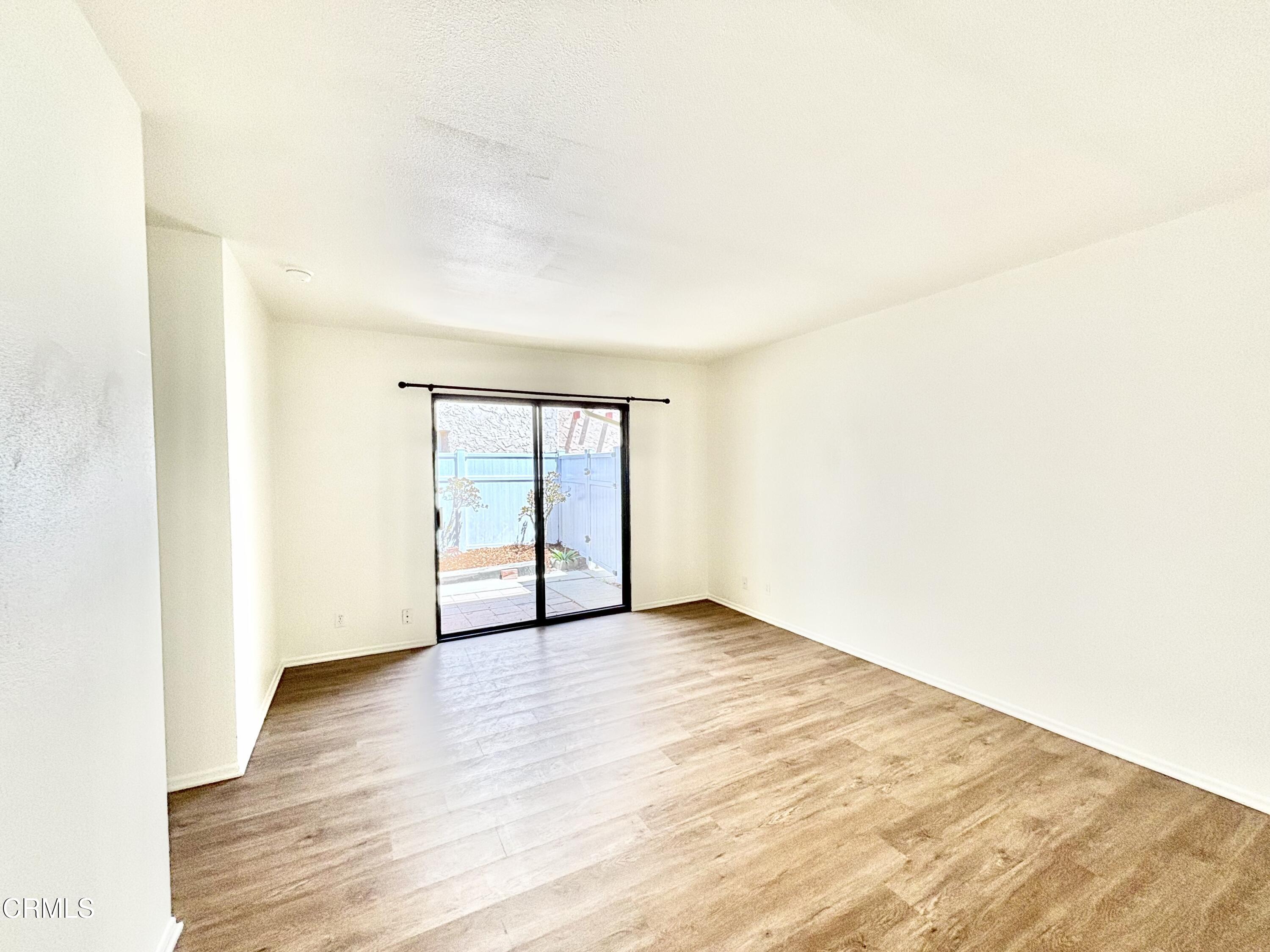 4911 Catamaran Street Oxnard, CA 93035 - Photo 29 of 38 a view of an empty room with wooden floor and a window